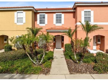 Two-story townhome with front yard landscaping and walkway at 8519 Bay Lilly Loop, Kissimmee, FL 34747