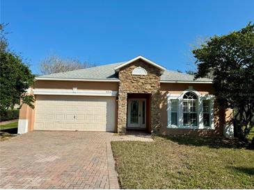 One-story house with stone accents and a two-car garage at 9714 Nonacrest Dr, Orlando, FL 32832