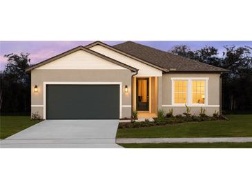 One-story home with gray siding, dark gray garage door, and landscaping at 1609 Hill Park Dr, Deltona, FL 32725