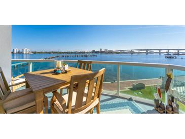 Waterfront balcony showcasing outdoor dining with beautiful views of the bay and city skyline at 241 Riverside Dr # 201, Daytona Beach, FL 32117