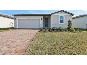 Charming single-story home featuring a brick driveway, attached garage and freshly landscaped front yard at 4543 Sidesaddle Trl, St Cloud, FL 34772