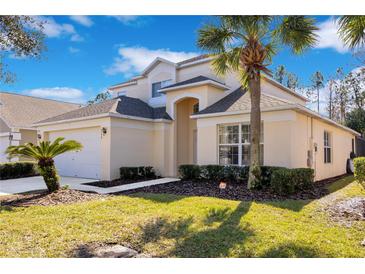 Two-story house with a two-car garage and landscaped lawn at 136 Madiera Beach Blvd, Kissimmee, FL 34746