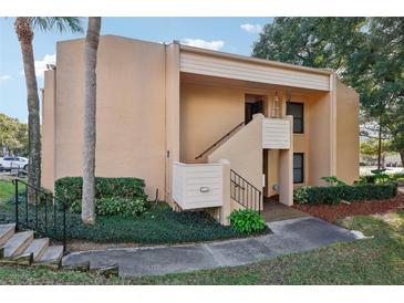 Exterior view of condo with stairs and landscaping at 600 Cranes Way # 206, Altamonte Springs, FL 32701
