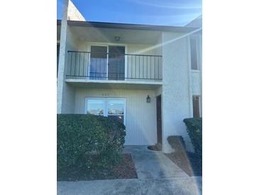Two-story condo features a balcony, well maintained yard, and neutral color scheme at 607 Waverly Ln # 403, Maitland, FL 32751