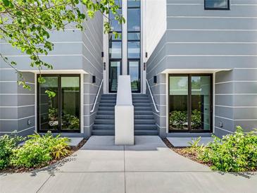 Modern two-story townhouses with gray siding and white accents at 1762 Mondrian Cir, Winter Park, FL 32789