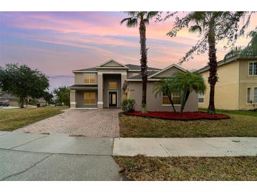 Two-story house with a paved driveway and landscaping at 5791 Covington Cove Way, Orlando, FL 32829