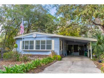 Cute light blue manufactured home with covered carport and mature landscaping at 151 E Plantation Blvd, Lake Mary, FL 32746