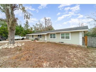 Charming single-story home featuring a well-manicured lawn and a welcoming entrance at 24908 County Road 561, Astatula, FL 34705