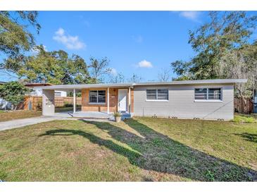 Home exterior showing the front yard, driveway and some trees at 3309 Drake Dr, Orlando, FL 32810