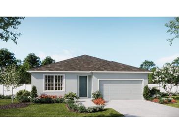 One-story home with gray siding, landscaping, and a two-car garage at 430 Marion Loop, Haines City, FL 33844