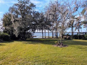 Spacious lakefront property with lush lawn and private dock at 9430 Kilgore Rd, Orlando, FL 32836