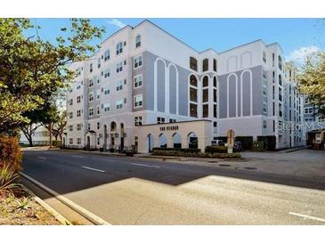 Beautiful condo building with white and gray exterior design and manicured landscaping at 202 E South St # 1048, Orlando, FL 32801