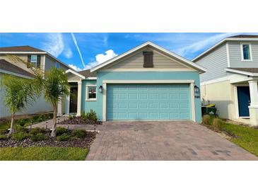 Charming, single-story home with a well-maintained front yard and a blue garage door at 2713 Runners Cir, Clermont, FL 34714