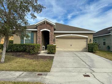Charming single-story home with a well-manicured lawn, two car garage, and a stone-accented entryway at 2931 Top Water Way, Kissimmee, FL 34746