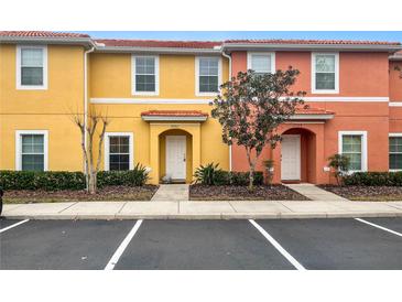 Two-story townhouses with appealing exterior finishes and landscaping at 3002 Red Ginger Rd, Kissimmee, FL 34747
