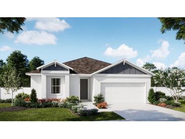 One-story home with white siding, brown roof, and landscaped yard at 426 Marion Loop, Haines City, FL 33844