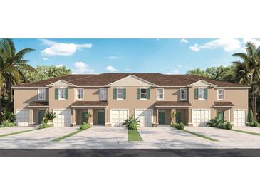 Three-unit townhome building with attached garages and landscaping at 668 Preston Cove Dr, St Cloud, FL 34771