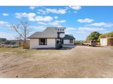 Two-story house with a gray roof and white siding, spacious yard at 13145 Paloma Rd, Clermont, FL 34711
