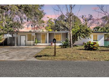 Charming single-story home with a covered porch and well-manicured lawn at 204 Louis St, Leesburg, FL 34748