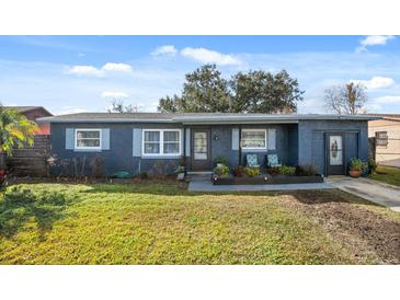 Charming single-story home featuring front yard, and covered front entry with decorative seating at 783 Cornelia Ct, Orlando, FL 32811