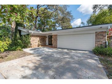 Charming single-story home featuring brick accents, mature landscaping, and a spacious two-car garage at 1221 Thunder Trl, Maitland, FL 32751
