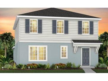 Two-story home with light blue siding, dark gray roof, and landscaping at 6923 Copperwood Ave, Orlando, FL 32829