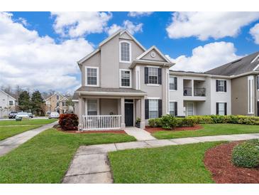 Two-story townhome with front porch and landscaping at 9141 Lee Vista Blvd # 305, Orlando, FL 32829