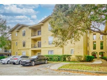Inviting condo with a stucco exterior, well-kept landscaping, and ample parking at 1341 Arbor Vista Loop # 321, Lake Mary, FL 32746