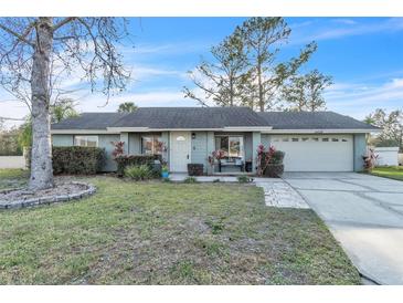 Charming single-story home with a well-maintained lawn, complemented by mature trees and tidy landscaping at 1428 Madrid Way, Winter Springs, FL 32708