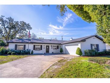 Charming single-story home featuring a well-manicured lawn, attached garage, and classic design elements at 2460 Worthington Rd, Maitland, FL 32751