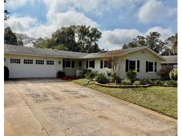 Ranch-style home with attached garage and mature landscaping at 3458 Balsam Dr, Winter Park, FL 32792