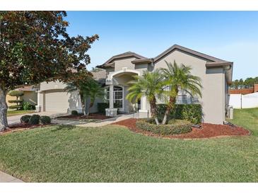 Charming single-story home with well-manicured landscaping and a welcoming front entrance at 369 Belhaven Falls Dr, Ocoee, FL 34761