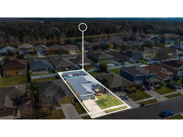 A captivating aerial view of a home, complete with a private pool and well-manicured lawn in a quiet neighborhood at 2783 Trommel Way, Sanford, FL 32771