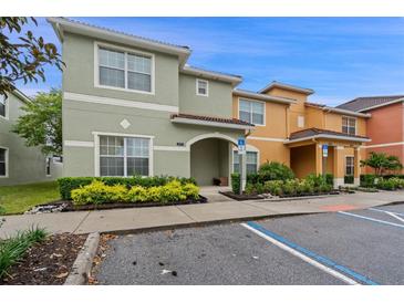 Exterior view of a two-story townhome with landscaping at 3071 Beach Palm Ave, Kissimmee, FL 34747