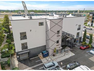 Modern building featuring unique exterior design, including a diamond pattern and convenient surface parking at 62 W Colonial Dr # 302, Orlando, FL 32801