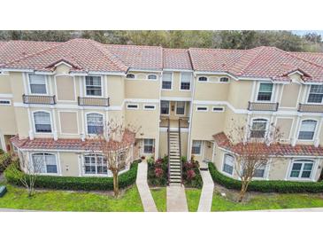 Inviting two-story townhome featuring a terracotta roof, landscaped walkway and charming facade at 980 Mooring Ave # 103, Altamonte Springs, FL 32714