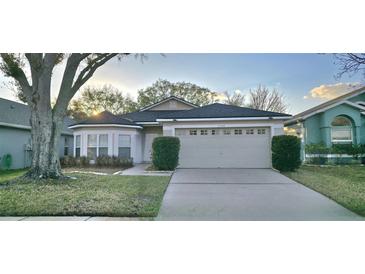 Charming single-story home featuring an attached two-car garage and mature landscaping at 14424 Quail Trail Ct, Orlando, FL 32837