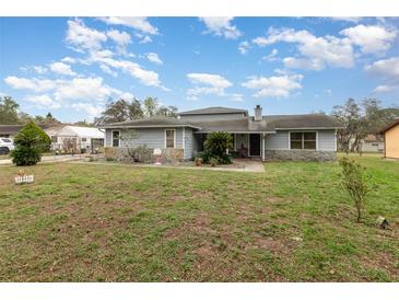 Inviting single-story home featuring stone accents, well-maintained lawn, and ample natural light at 2357 Palm Way, Oviedo, FL 32765