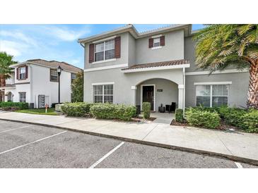 Two-story house with gray siding, brown accents, and landscaping at 3097 Pequod Pl, Kissimmee, FL 34746