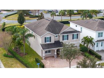 Well-maintained two-story home with a manicured lawn and lush landscaping on a corner lot at 7600 Mackinaw Ln, Kissimmee, FL 34747