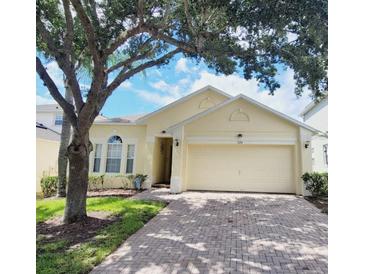 Charming single-story home with a two-car garage and well-maintained landscaping at 124 Lancaster Dr, Davenport, FL 33897