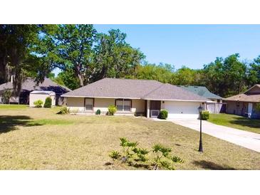 Charming single-story home with well-maintained lawn and landscaping at 18148 Villa City Rd, Groveland, FL 34736
