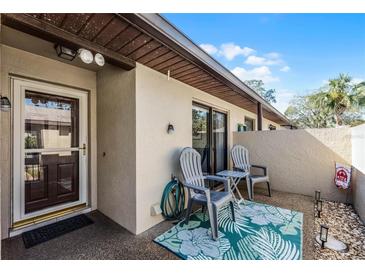 Cozy patio features an outdoor seating area, perfect for relaxing or entertaining guests at 2214 Se Sawgrass Ct, Winter Haven, FL 33884