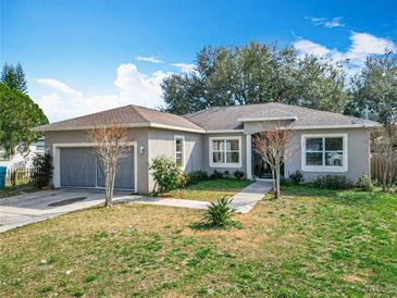 Charming one-story home with mature landscaping and a two-car garage at 2218 W Gore St, Orlando, FL 32805