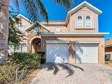 Charming two-story home with three car garage and brick paved driveway at 2632 Sand Hill Point Cir, Davenport, FL 33837