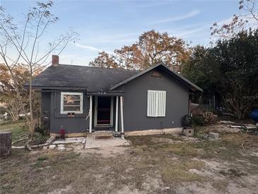 Dark gray house with a small porch and yard at 310 Lake Ave, Dundee, FL 33838
