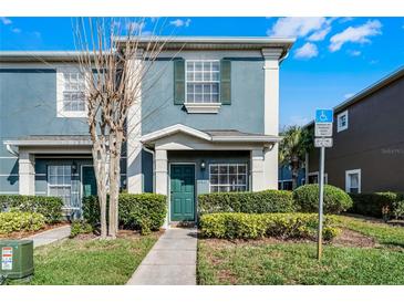 Charming two-story home with a well-maintained lawn and colorful exterior paint at 10421 Manderley Way # 268, Orlando, FL 32829