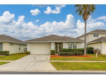 Single-story home with attached garage and landscaped lawn at 2983 Sunset Vista Blvd, Kissimmee, FL 34747
