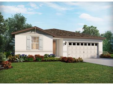 One-story home with front yard landscaping, two-car garage, and light-colored exterior at 321 Castle Dr, Lake Alfred, FL 33850