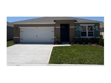 Charming single-story home featuring a well-manicured lawn and a paved driveway leading to an attached garage at 3510 Sandalwood Isle Way, Ocoee, FL 34761